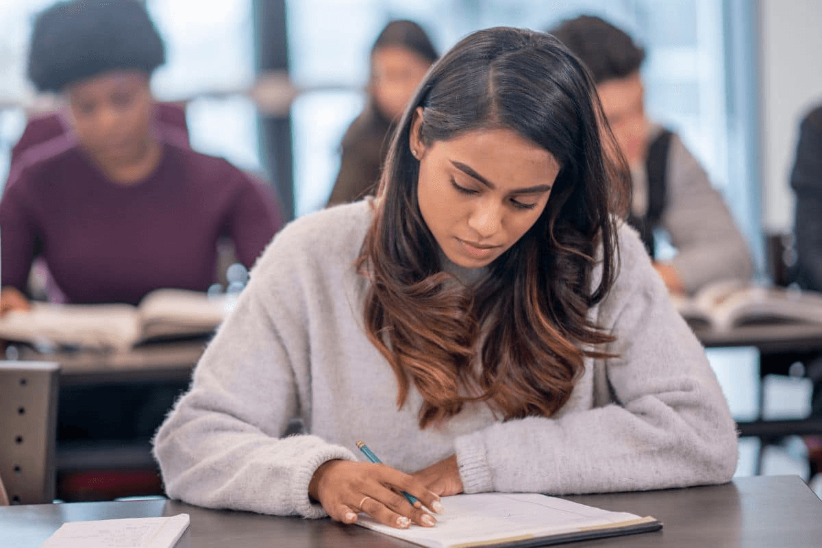 Student writing in a notebook
